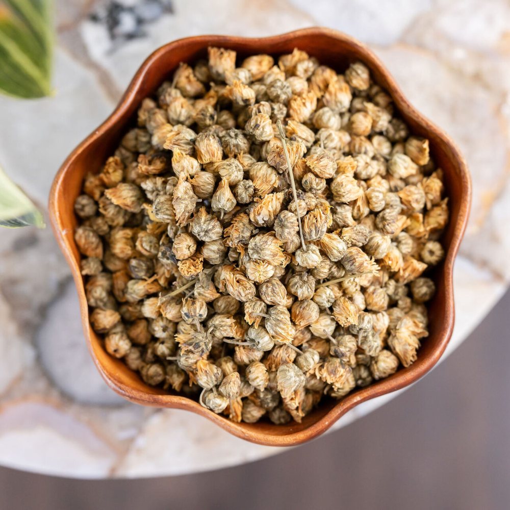 Bowl of dried chrysanthemum buds used in Chinese herbal medicine